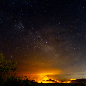 Bighorn fire over the Santa Catalina Mountains in 2020 with the Milkey Way in the sky above.