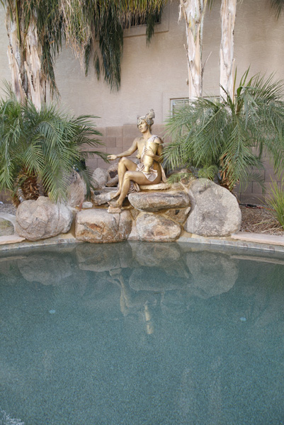 Reflections in the pool of the Wish Inc. Statue