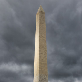 A random ray of sunlight shines through the overcast sky onto the Washington Memorial in Washington D.C.