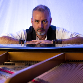 Mark Greenawalt headshot at the Samick Grand Piano