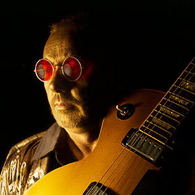 Singer Songwriter Mark Greenawalt with my Gold Top Les Paul electric guitar and gold facepaint with rose colored glasses