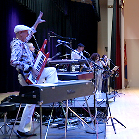 Mark Greenawalt playing keyboards with The Polyesters on the Keytar and the Fender Rhodes.